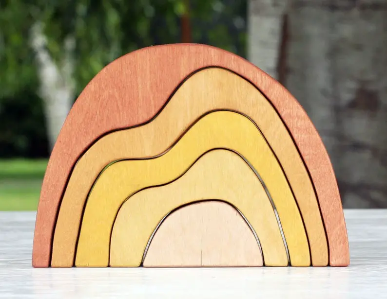 sun colored abstract mountain style wooden rainbow toy