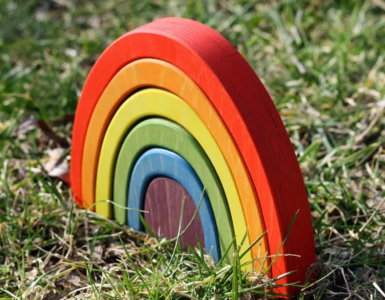waldorf wooden rainbow toy in grass