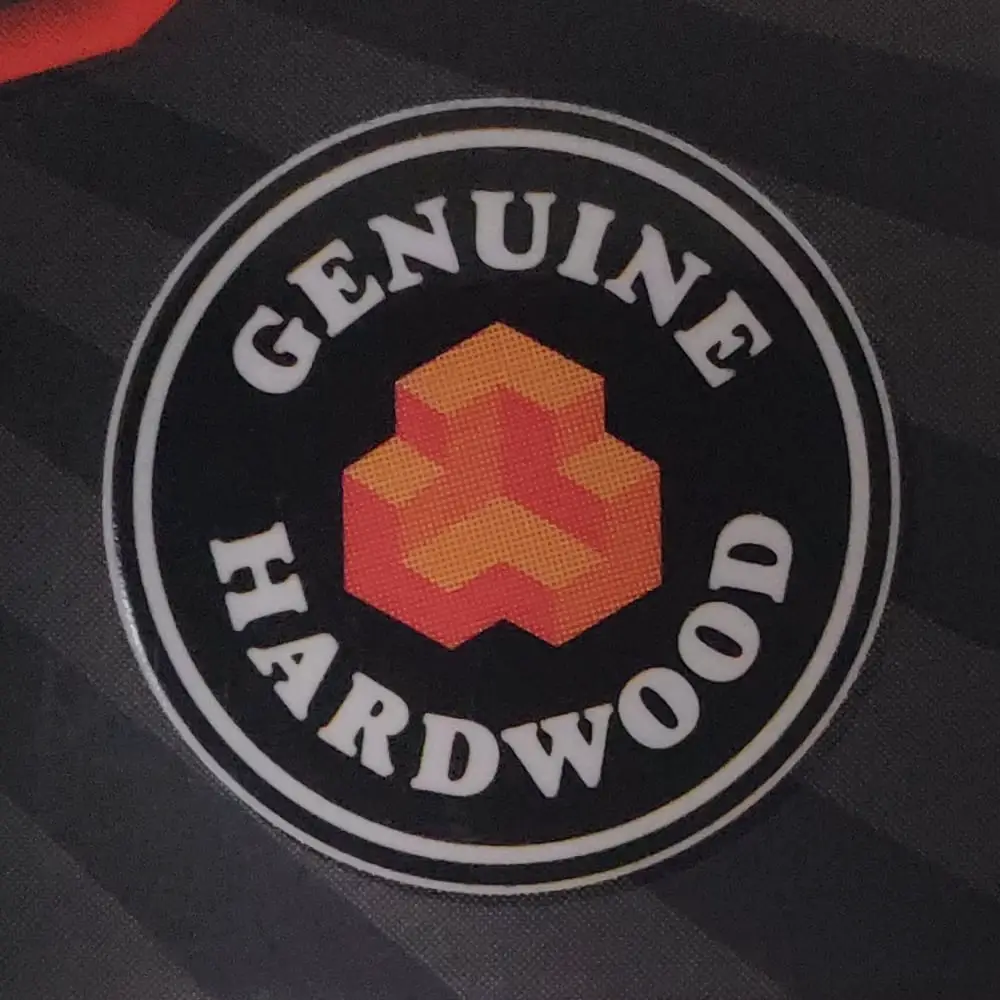 Jenga Classic packaging badge design with words "Genuine Hardwood".