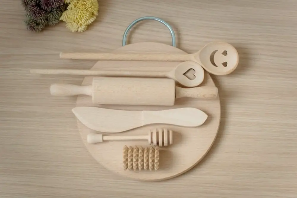 Montessorians brand wooden playdough toolset with circular cutting board.