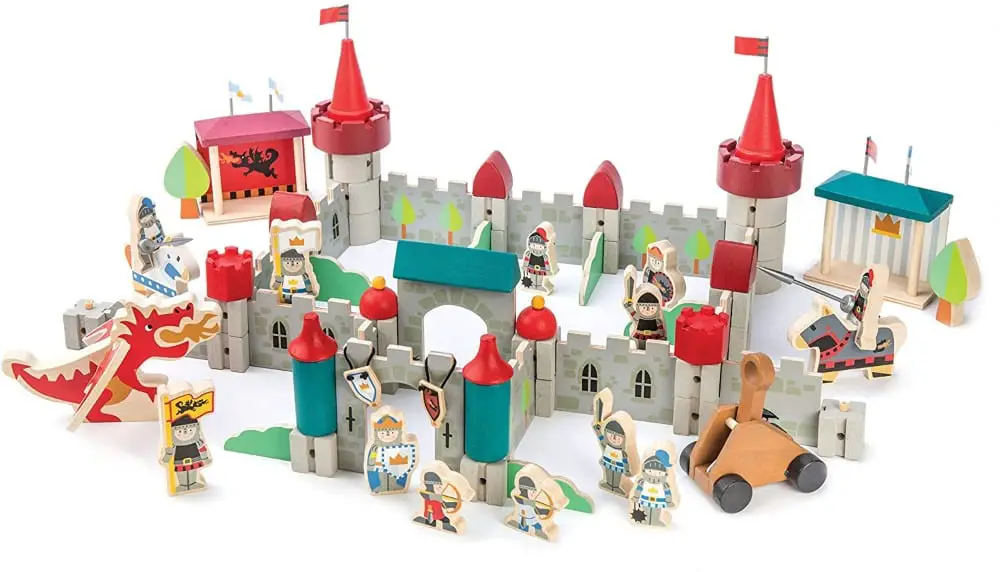 Tender Leaf Toys brand large Royal Castle wooden castle blocks set with figurines knights, horses, dragon, and trebuchet.