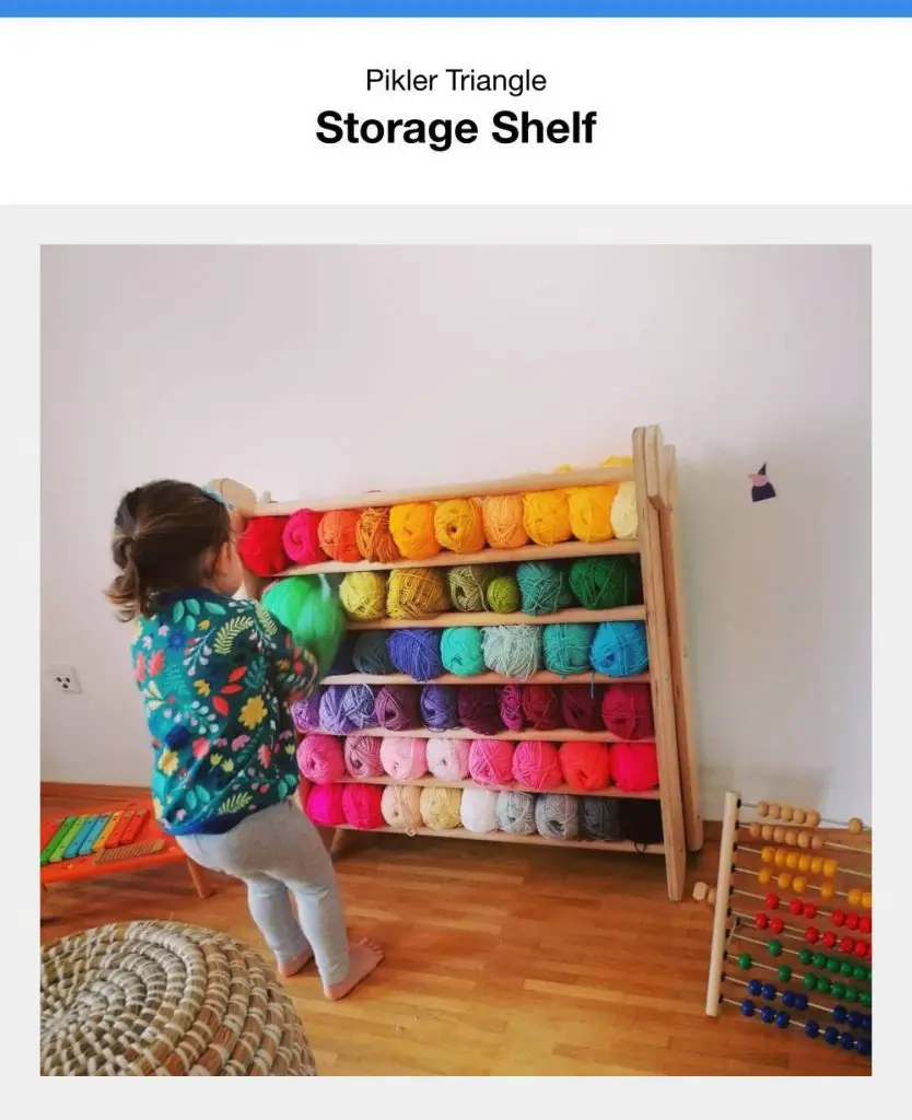 Pikler Triangle With Yarn Stuffed Between Rungs Like A Storage Shelf